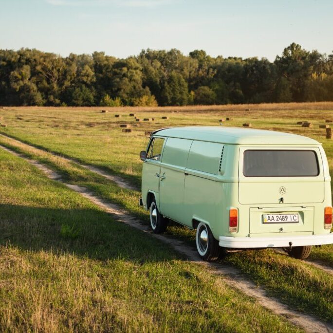 Green,Classic,Volkswagen,Transporter,On,Field,Road,Driving,Away.,Van