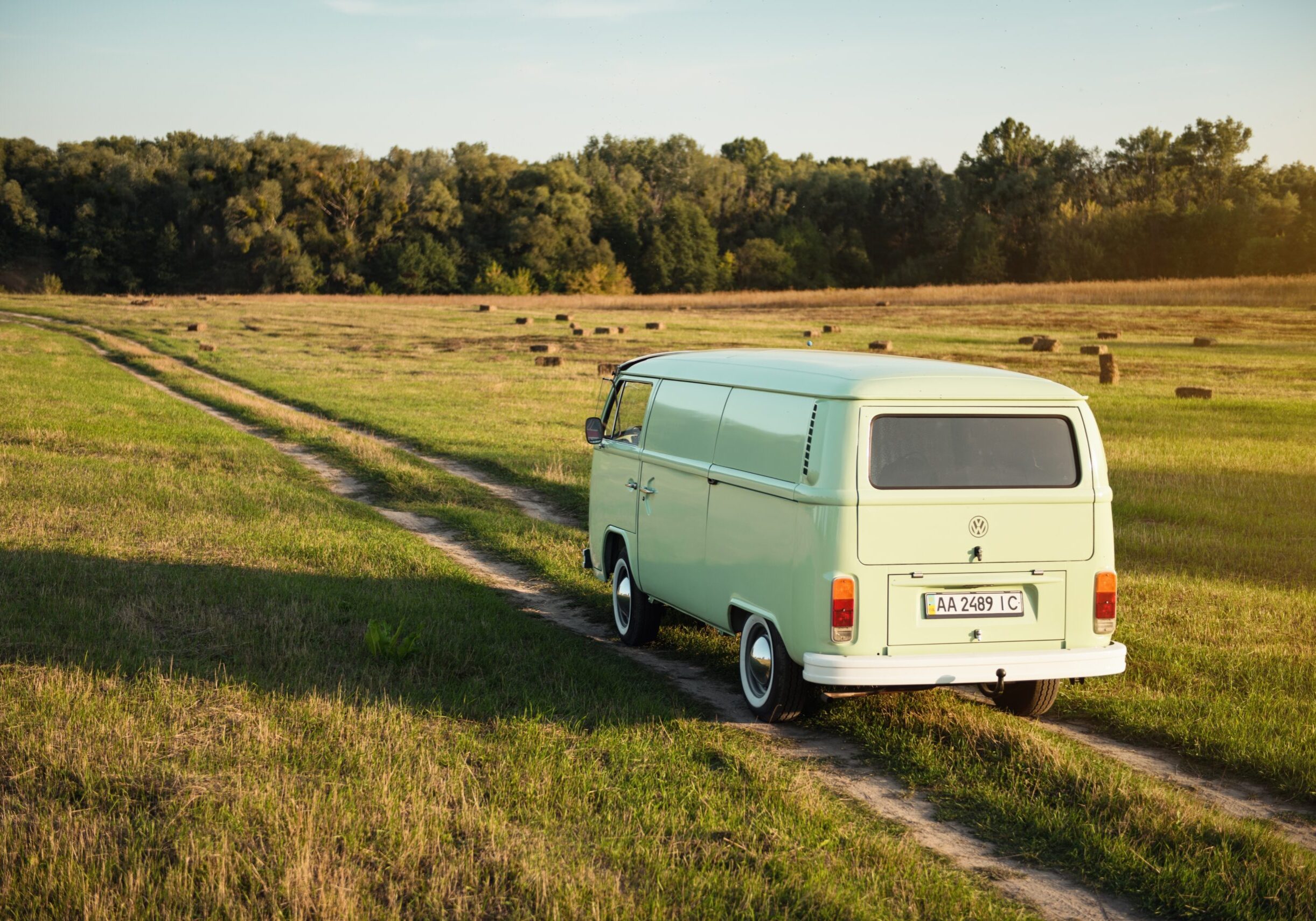 Green,Classic,Volkswagen,Transporter,On,Field,Road,Driving,Away.,Van