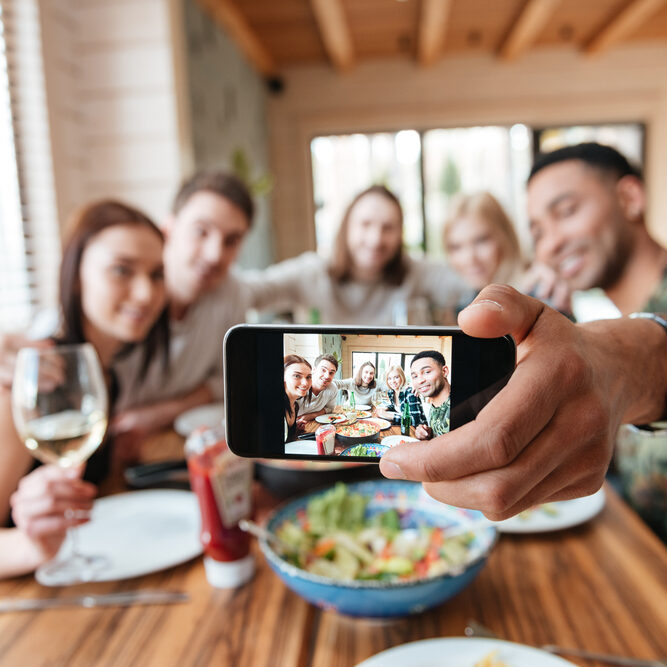 Group,Of,Friends,Having,Dinner,And,Taking,Selfie,With,Smartphone