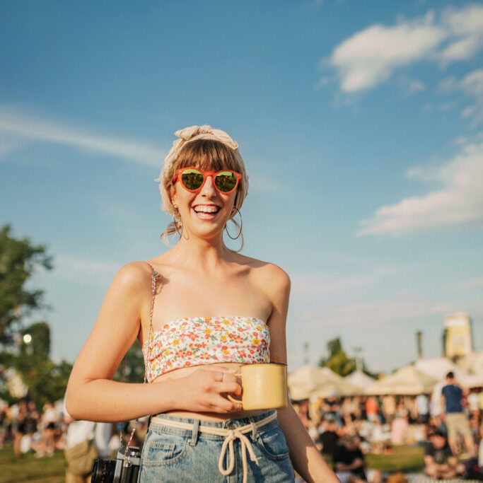 Young woman enjoys a warm summer day. Festival lady.