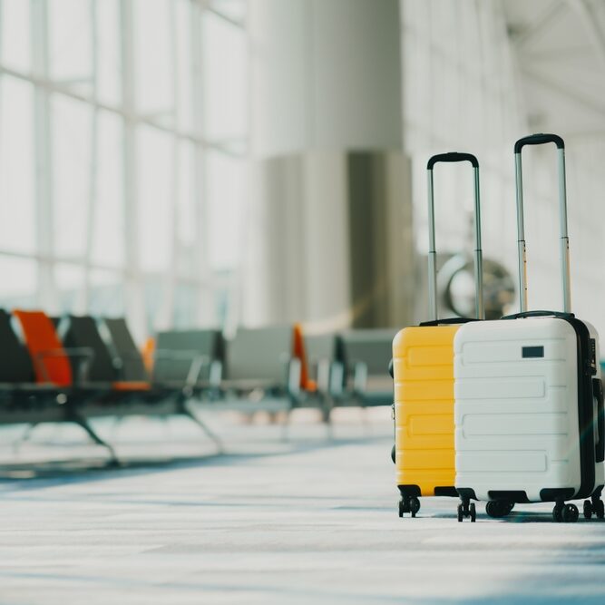 Two,Suitcases,In,An,Empty,Airport,Hall,,Traveler,Cases,In