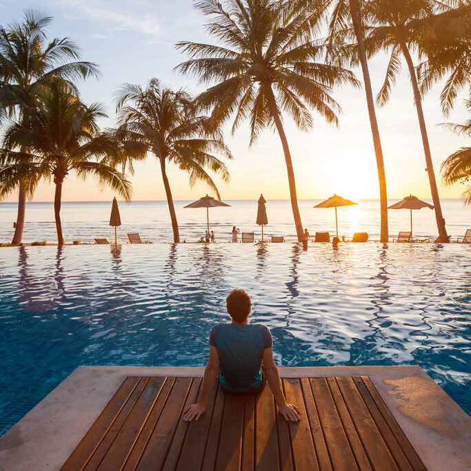 long-beach-island-nj-swimming-pool summer holiday getaway in luxury beach hotel, tourist relaxing near luxurious swimming pool at sunset, vacation on tropical island