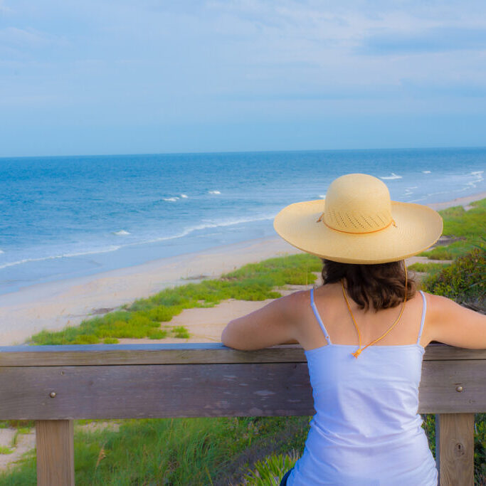 A visitor to the east coast of Florida watches the beautiful blue waters of the Atlantic Ocean and the beach just south of St. Augustine, Florida.