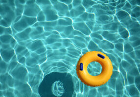 Yellow,Pool,Ring,Floating,In,A,Refreshing,Cool,Blue,Swimming