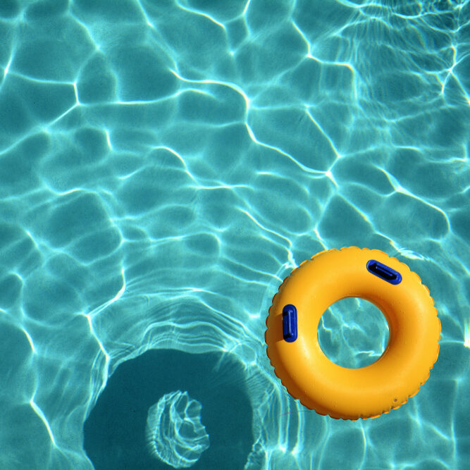 Yellow,Pool,Ring,Floating,In,A,Refreshing,Cool,Blue,Swimming